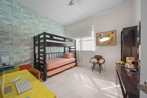 a bedroom with furniture and a window