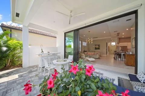 a living room with furniture and flowers