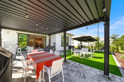 a view of a patio with a table chairs and a backyard