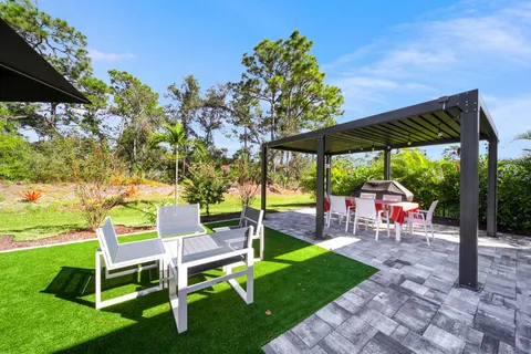 a view of a chair and table in the garden