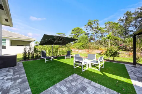 a view of yard with outdoor seating and green space