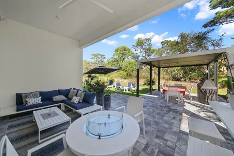 a living room with furniture and a floor to ceiling window