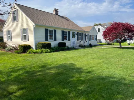 a front view of a house with a garden