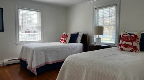a bedroom with two beds and a couch