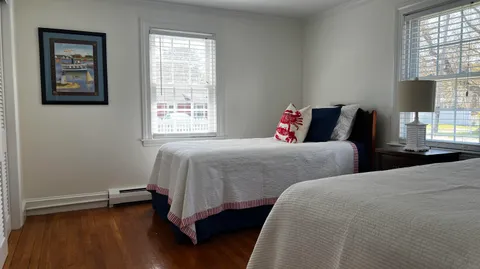 a bedroom with two beds and a window