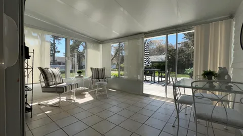a living room with furniture and large windows