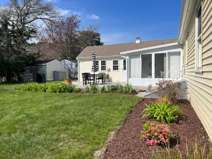 a front view of a house with a garden
