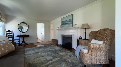 a living room with furniture a window and a fireplace
