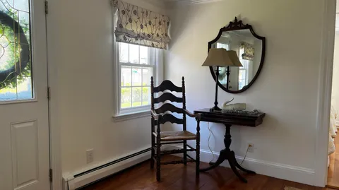 a view of a livingroom with furniture and wooden floor