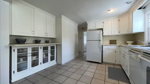 a utility room with cabinets washer and dryer