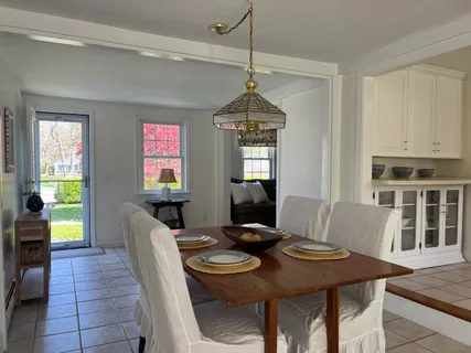 a view of a dining room with furniture and window