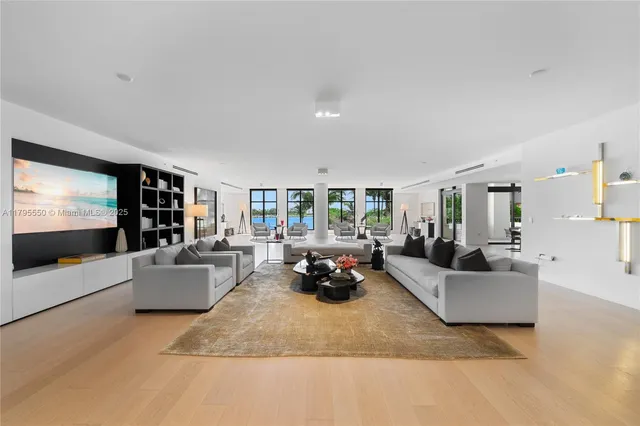 a living room with furniture and a floor to ceiling window