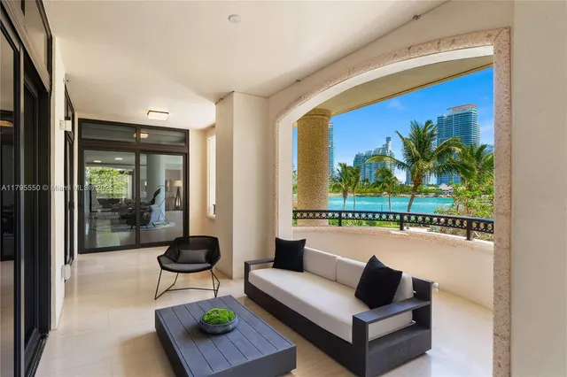 a living room with furniture and a floor to ceiling window