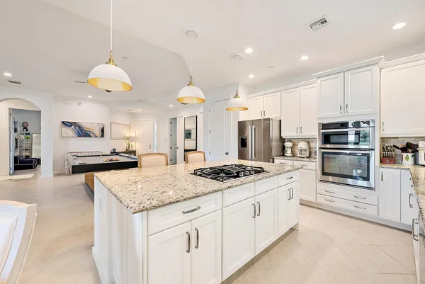 a kitchen with stainless steel appliances granite countertop a sink stove and cabinets