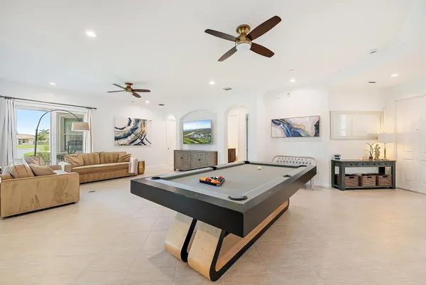 a view of a dining room with furniture a chandelier and wooden floor