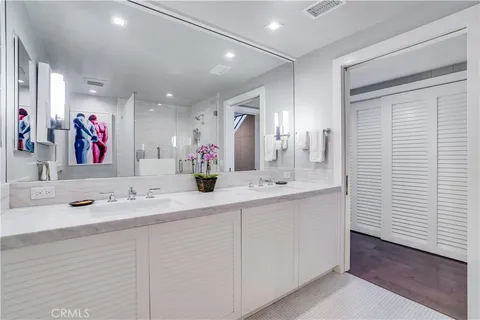 a bathroom with a sink double vanity and a mirror