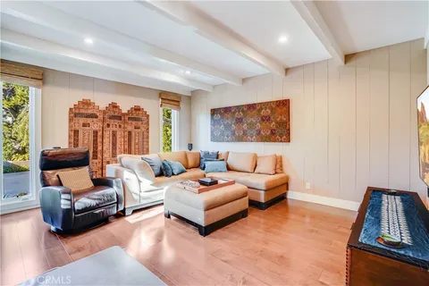 a living room with furniture rug and wooden floor