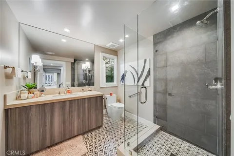 a large white bathroom with a sink a toilet and shower