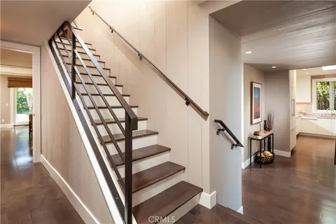 a view of entryway with wooden floor and stairs