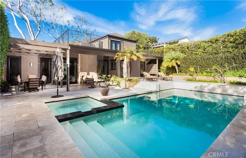 a view of a swimming pool with outdoor seating