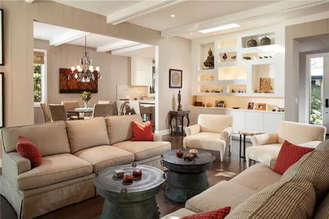 a living room with furniture and a chandelier