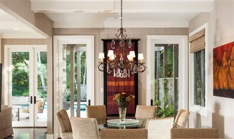 a view of a dining room with furniture wooden floor and chandelier