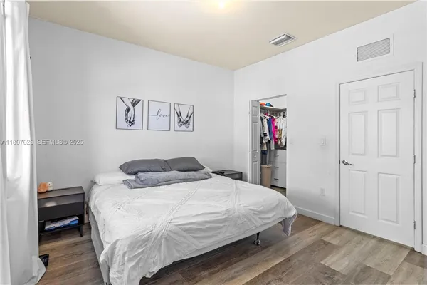 a bedroom with a bed and a closet