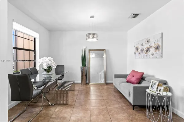 a living room with furniture and flowers