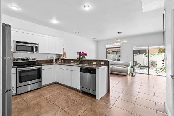 a kitchen with a stove a sink and a refrigerator