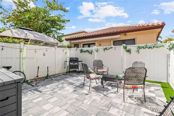 a patio with table and chairs