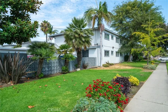 a front view of house with a garden