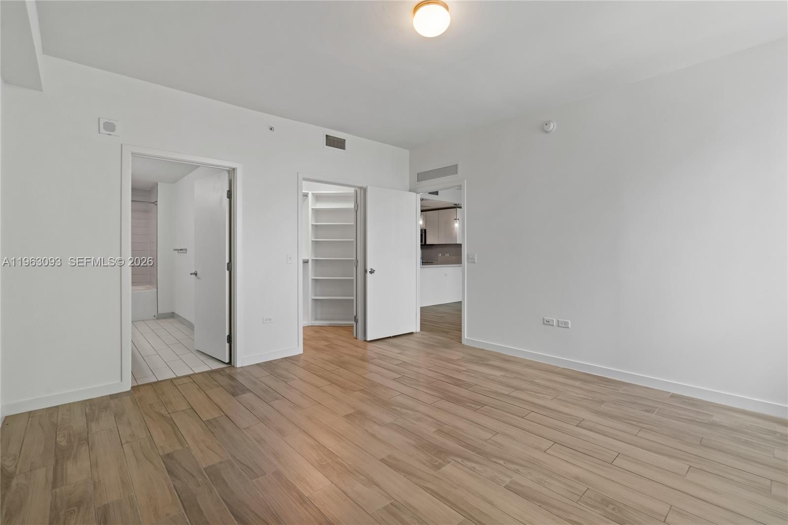999 Southwest 1st Avenue, Unit 2411 Miami, FL 33130 - Photo 17 of 72 a view of empty room with wooden floor