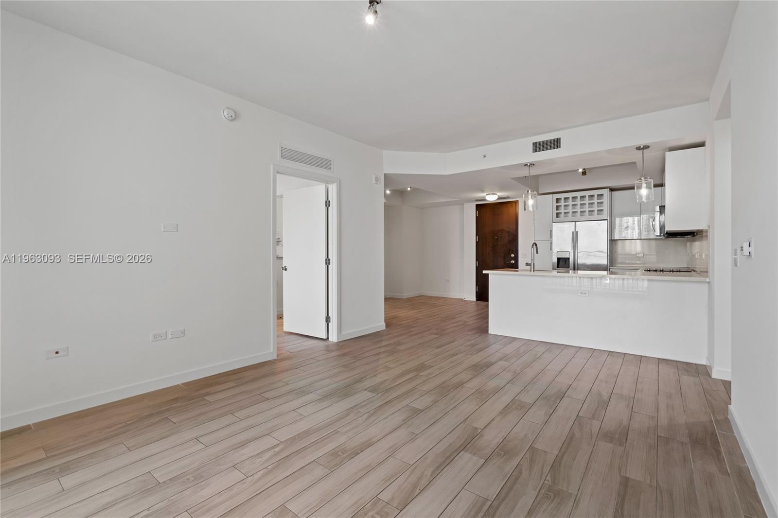 999 Southwest 1st Avenue, Unit 2411 Miami, FL 33130 - Photo 2 of 72 a view of a kitchen with wooden floor and a sink