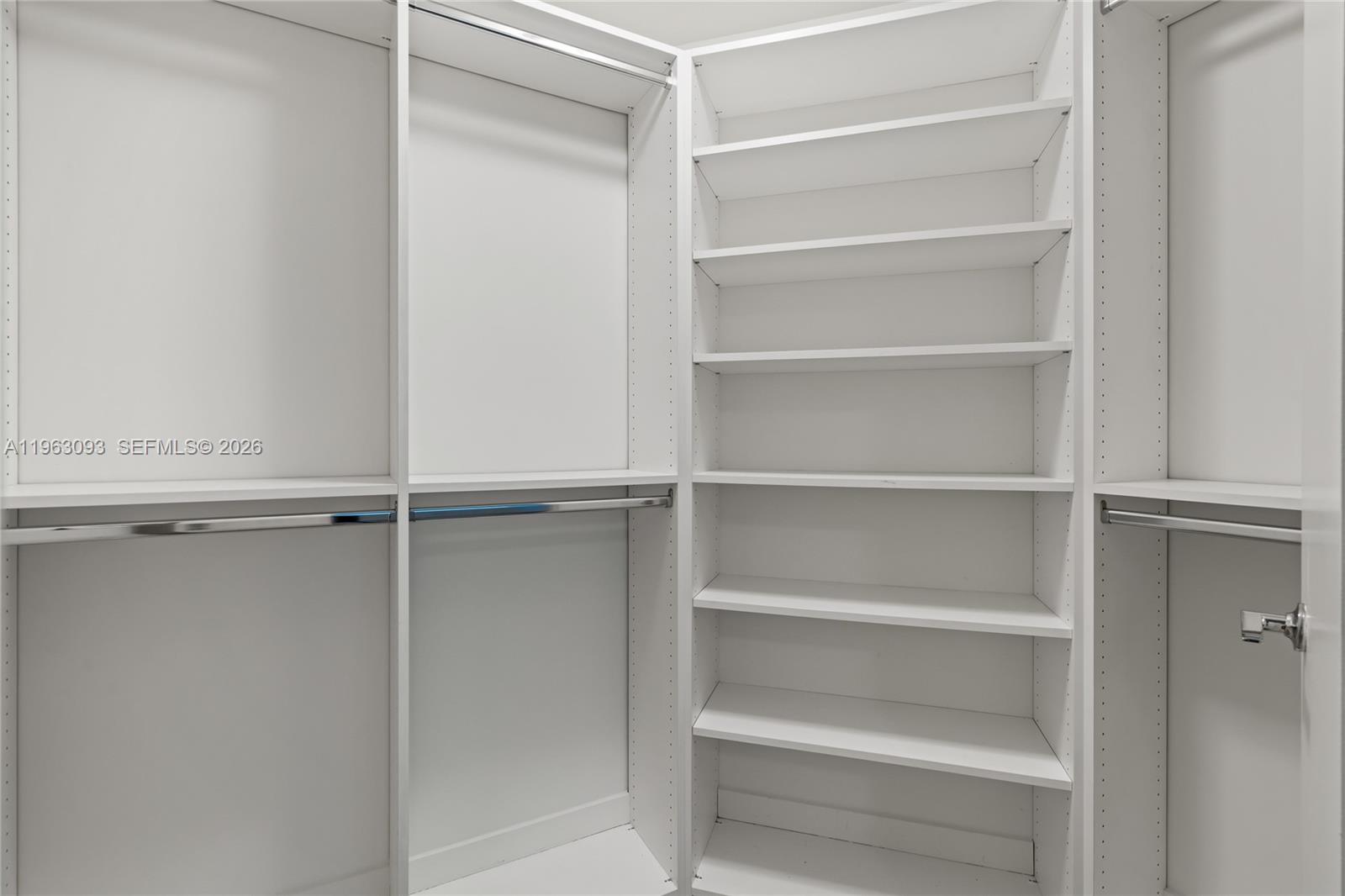 999 Southwest 1st Avenue, Unit 2411 Miami, FL 33130 - Photo 21 of 72 a view of walk in closet with empty racks