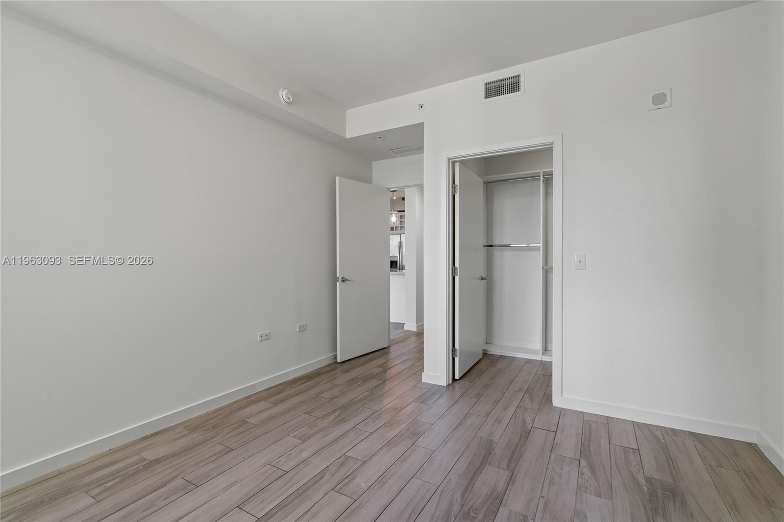 999 Southwest 1st Avenue, Unit 2411 Miami, FL 33130 - Photo 23 of 72 an empty room with wooden floor