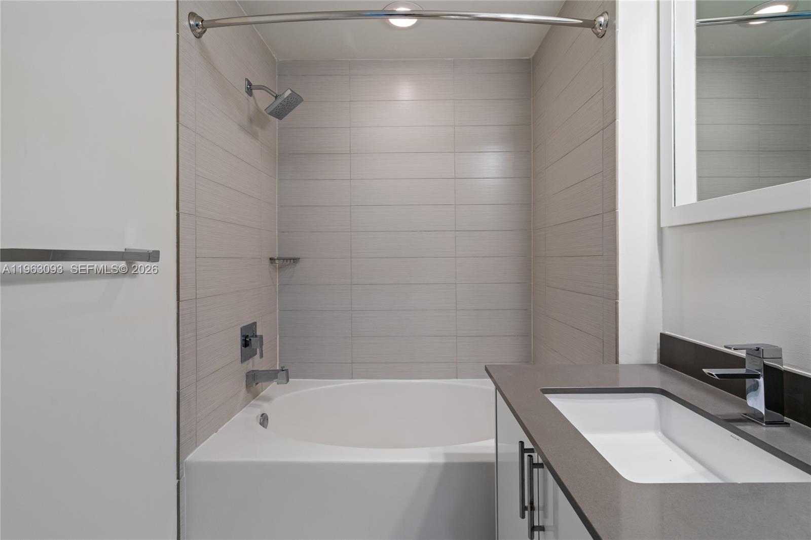 999 Southwest 1st Avenue, Unit 2411 Miami, FL 33130 - Photo 25 of 72 a bathroom with a sink and a bathtub