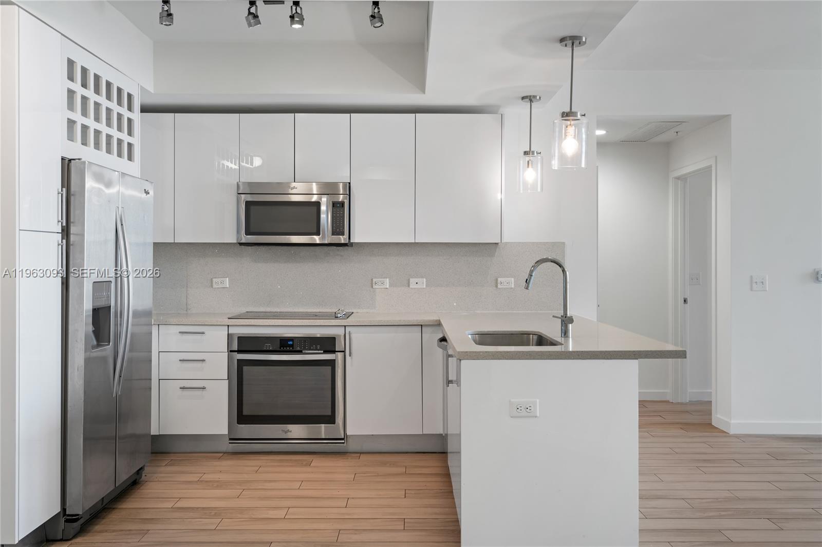 999 Southwest 1st Avenue, Unit 2411 Miami, FL 33130 - Photo 3 of 72 a kitchen with stainless steel appliances a stove sink and refrigerator