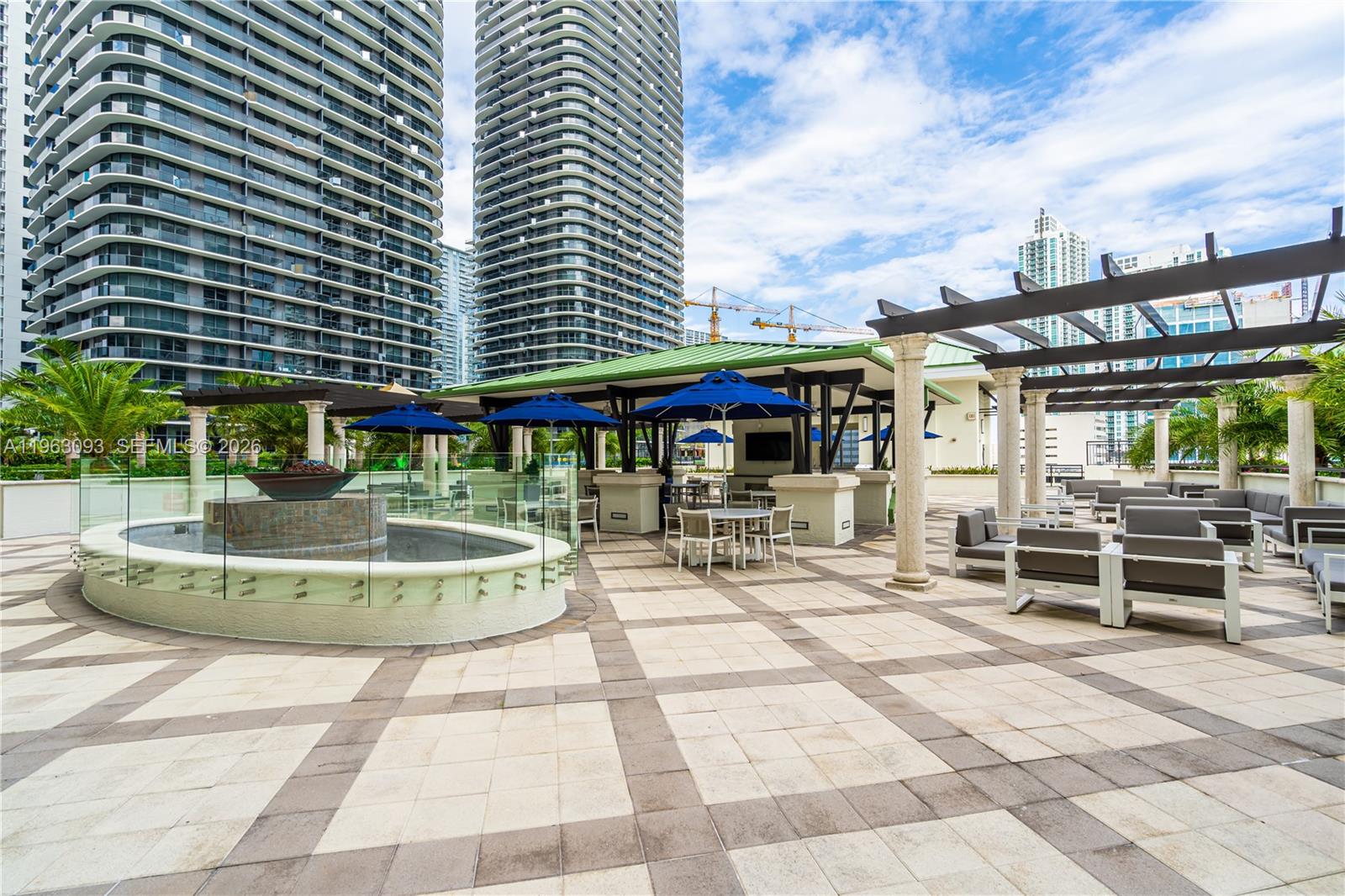999 Southwest 1st Avenue, Unit 2411 Miami, FL 33130 - Photo 44 of 72 a patio with a table and chairs and potted plants