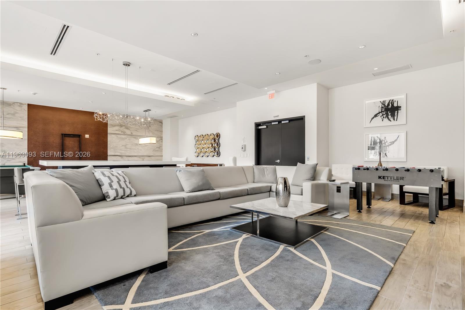 999 Southwest 1st Avenue, Unit 2411 Miami, FL 33130 - Photo 55 of 72 a living room with couches a coffee table and a flat screen tv