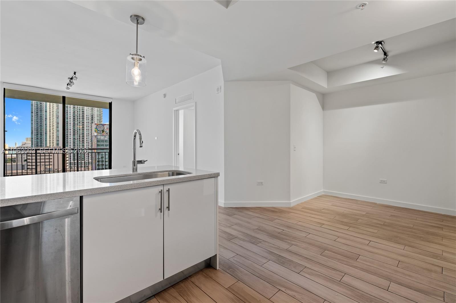 999 Southwest 1st Avenue, Unit 2411 Miami, FL 33130 - Photo 8 of 72 a view of a kitchen counter space a sink and wooden floor