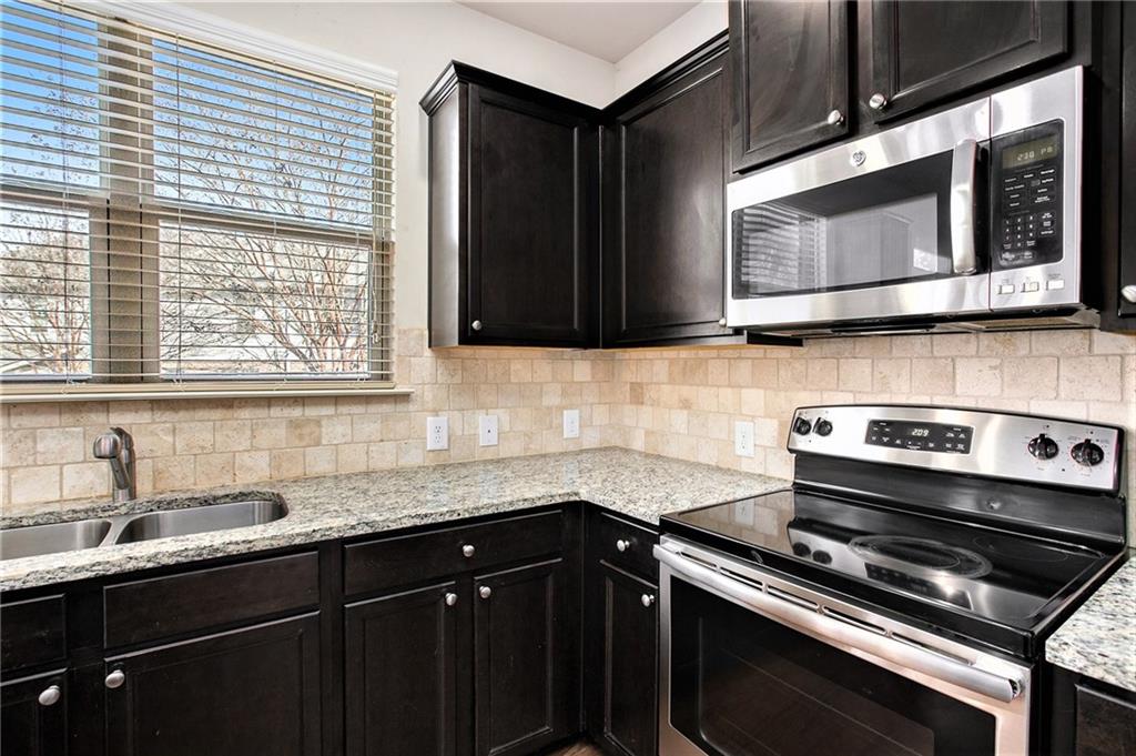 2426 Bellyard Drive Buford, GA 30519 - Photo 12 of 25 a kitchen with a sink stove and microwave