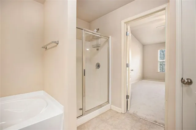 a bathroom with a tub shower and a sink