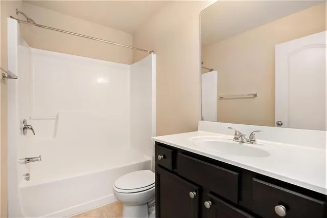 a bathroom with a sink a toilet a shower and a mirror