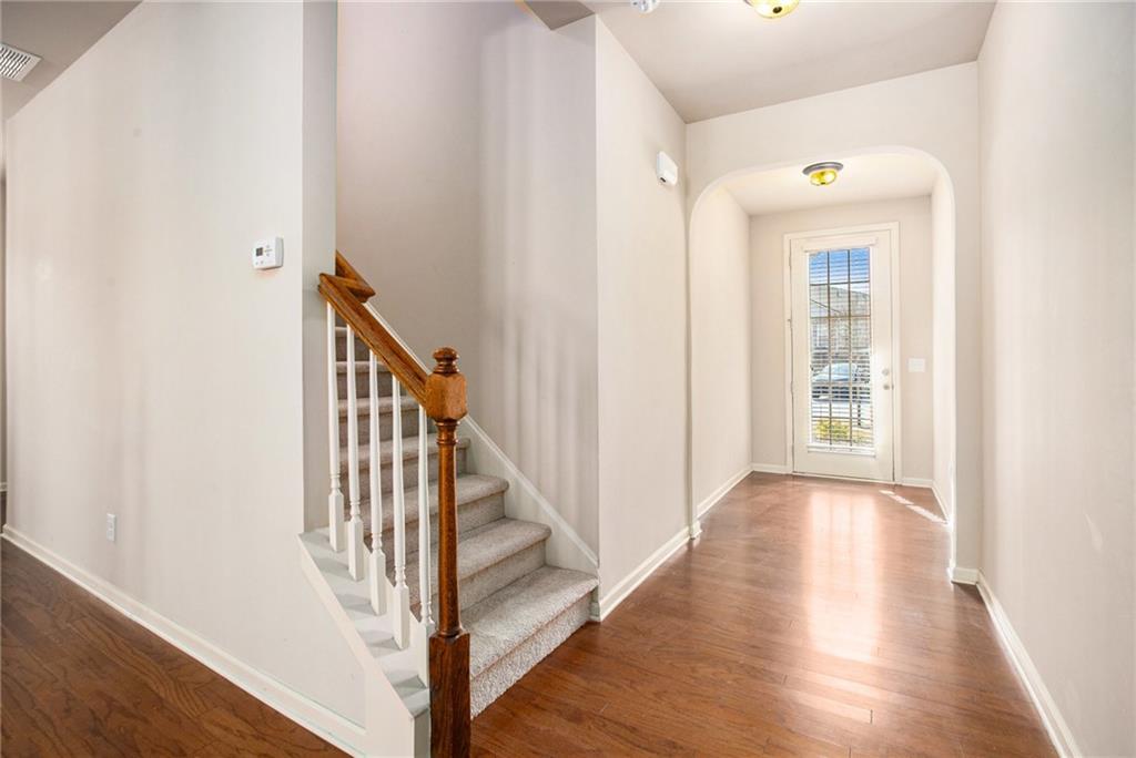 2426 Bellyard Drive Buford, GA 30519 - Photo 5 of 25 a view of a hallway with wooden floor and staircase