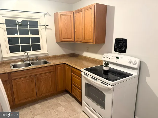 a view of backyard with wooden fence