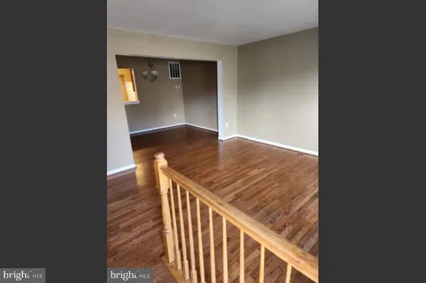 a view of a hallway view with wooden floor and staircase