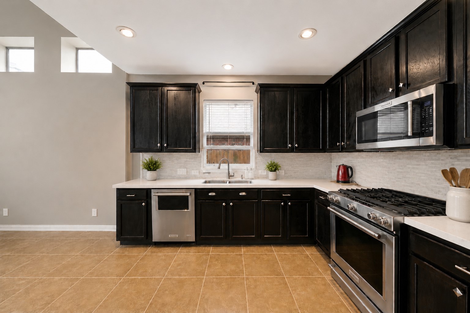 9438 Emerald Lakes Drive Rosharon, TX 77583 - Photo 8 of 36 a large kitchen with stainless steel appliances granite countertop a stove a sink dishwasher and a microwave oven on the stove