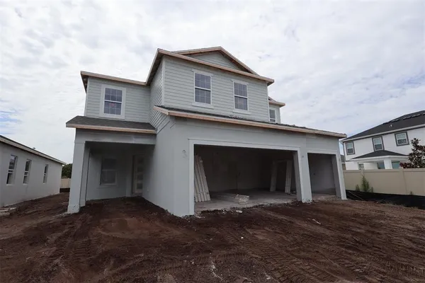 a view of a house with a yard and garage