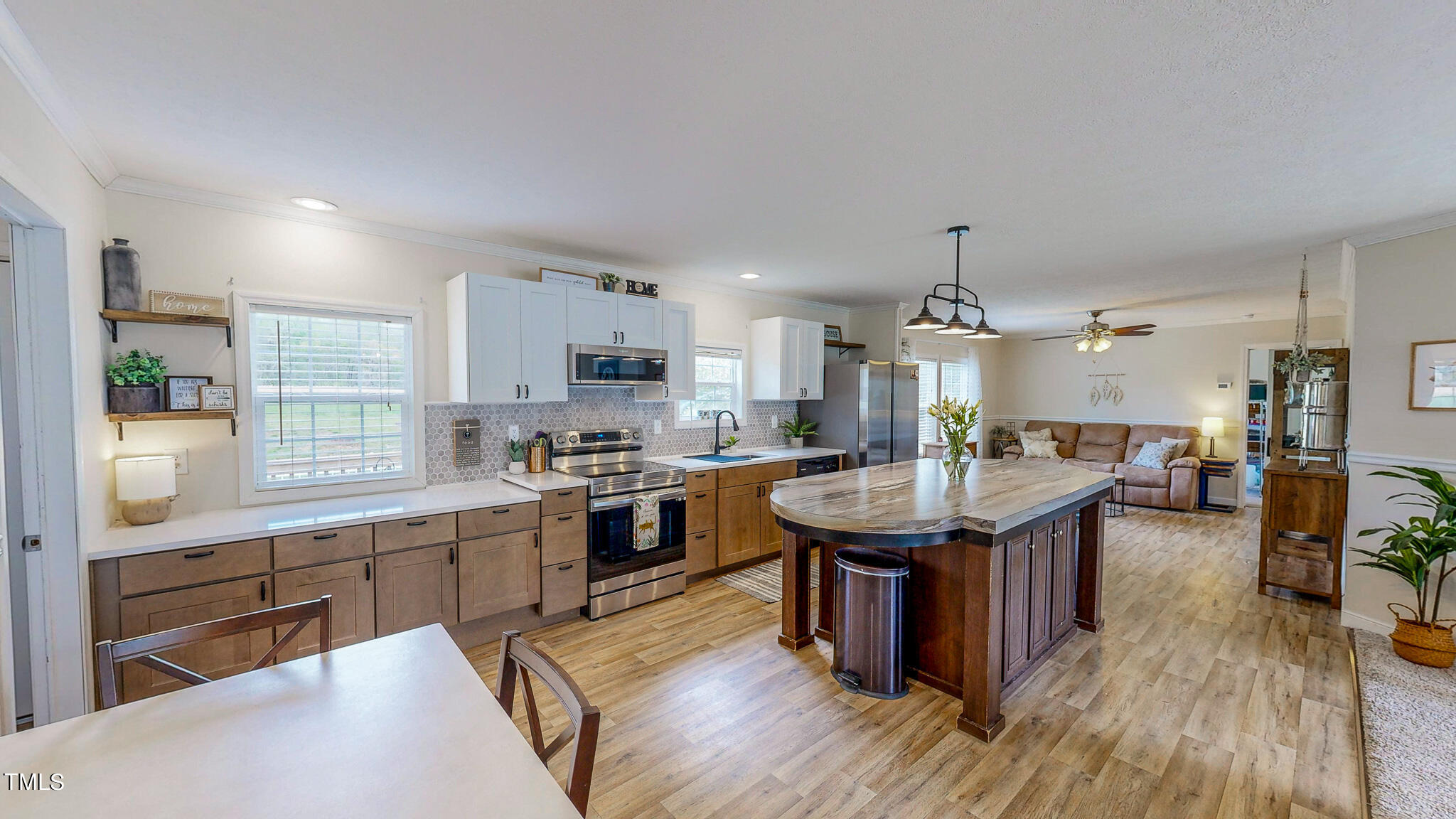 283 Dink Ashley Road Timberlake, NC 27583 - Photo 3 of 32 a kitchen with a sink stove and wooden floor