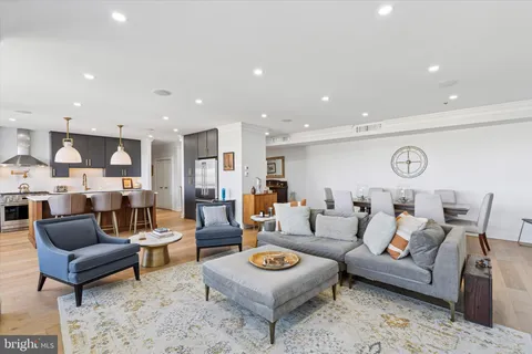 a living room with furniture kitchen view and a table
